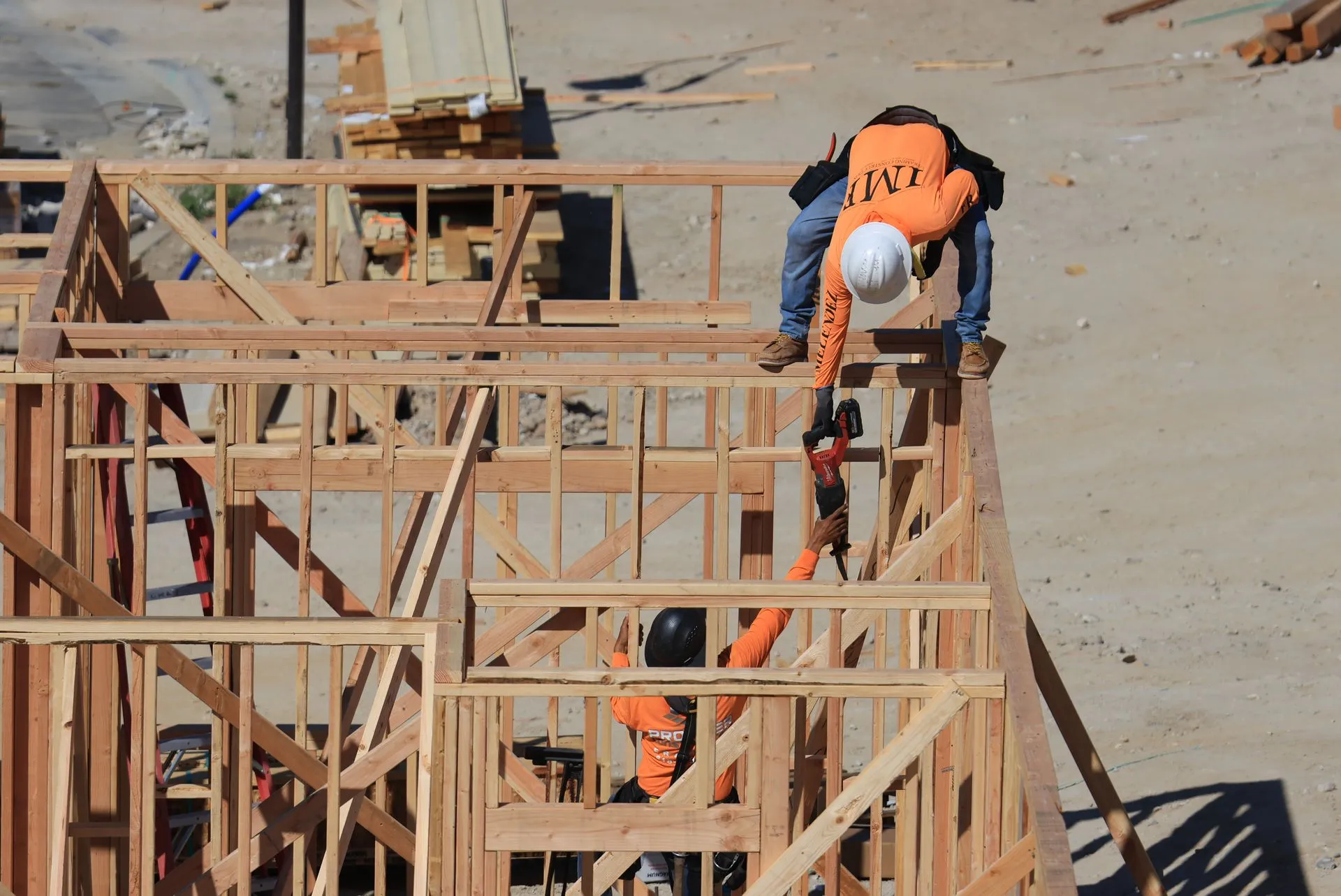 Builders framing a timber house