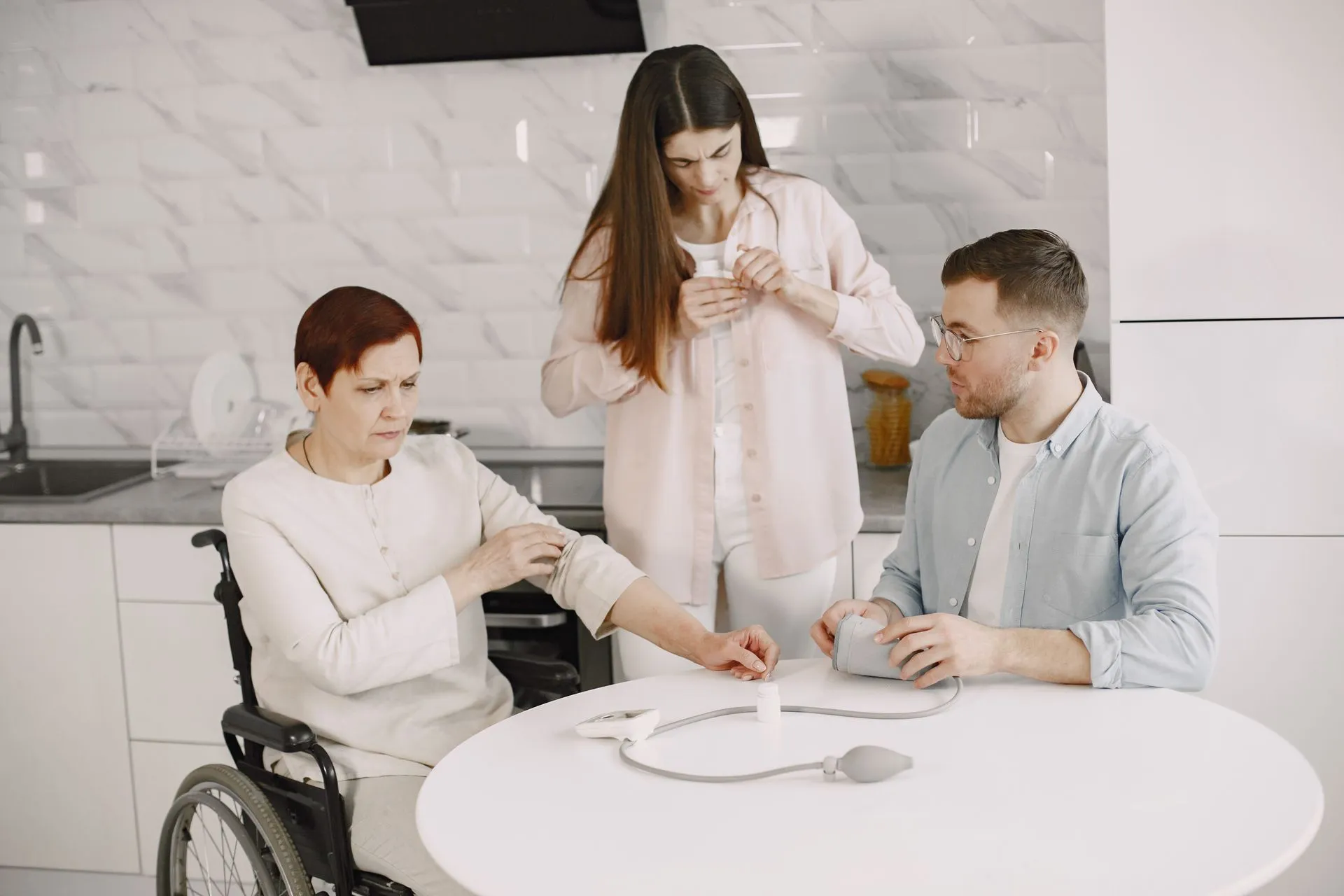 Family helping an older woman with a health check at home