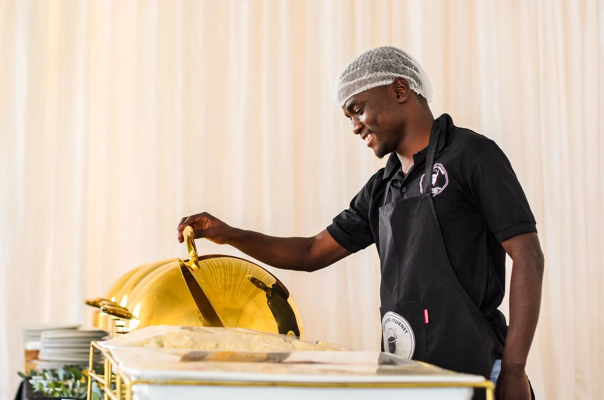 Caterer serving food at a buffet