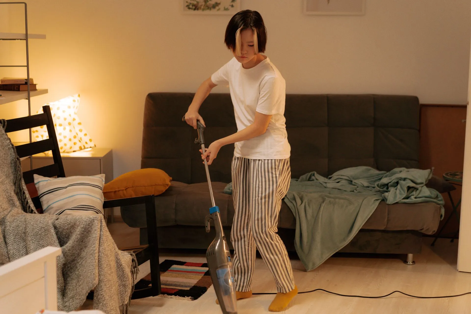Cleaner vacuuming a living room