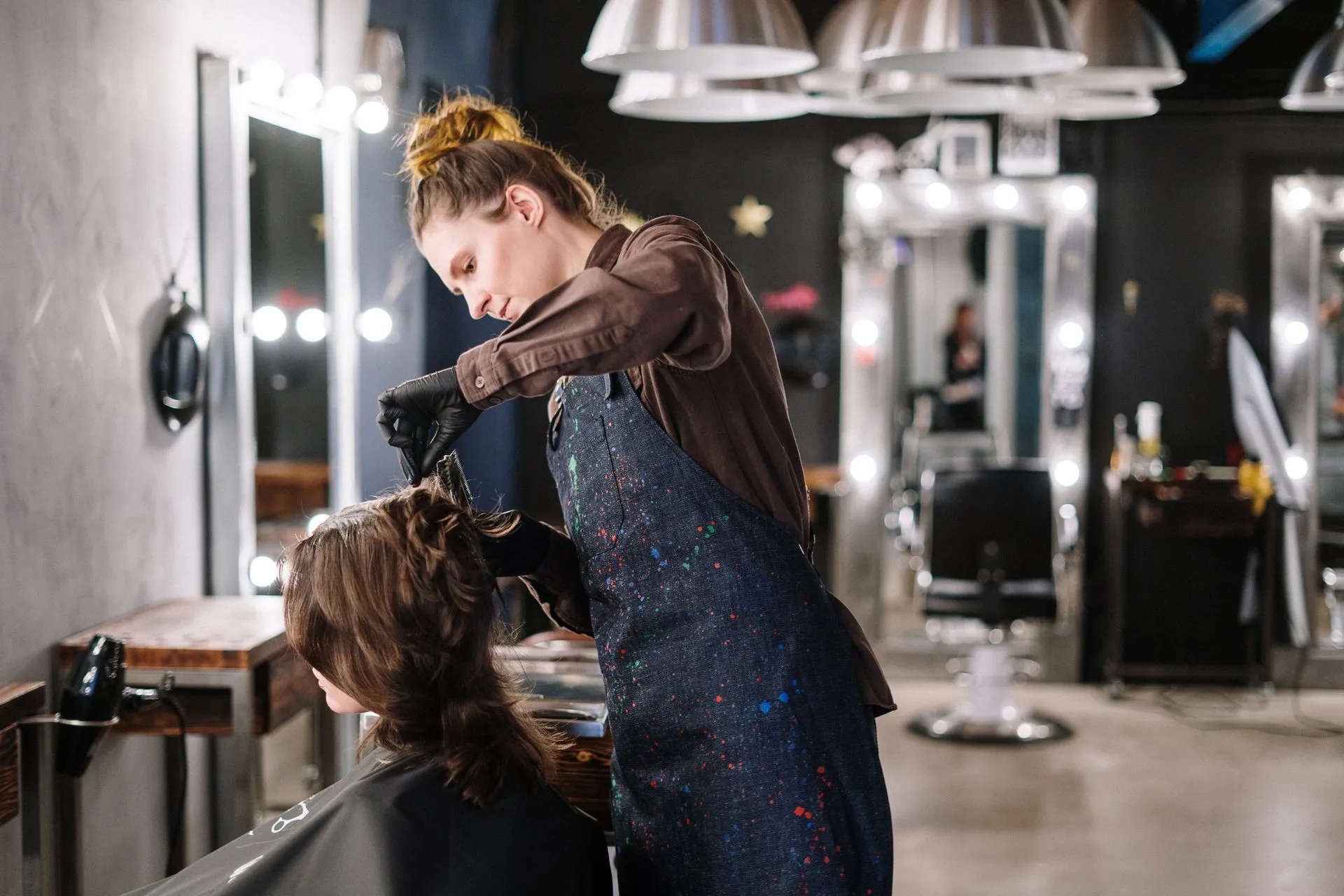 Hairdresser styling a client in a salon
